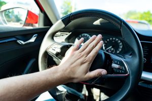 Someone pressing a car horn