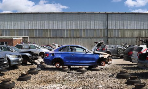 Blue Scrap Car in a U-Pull-It yard